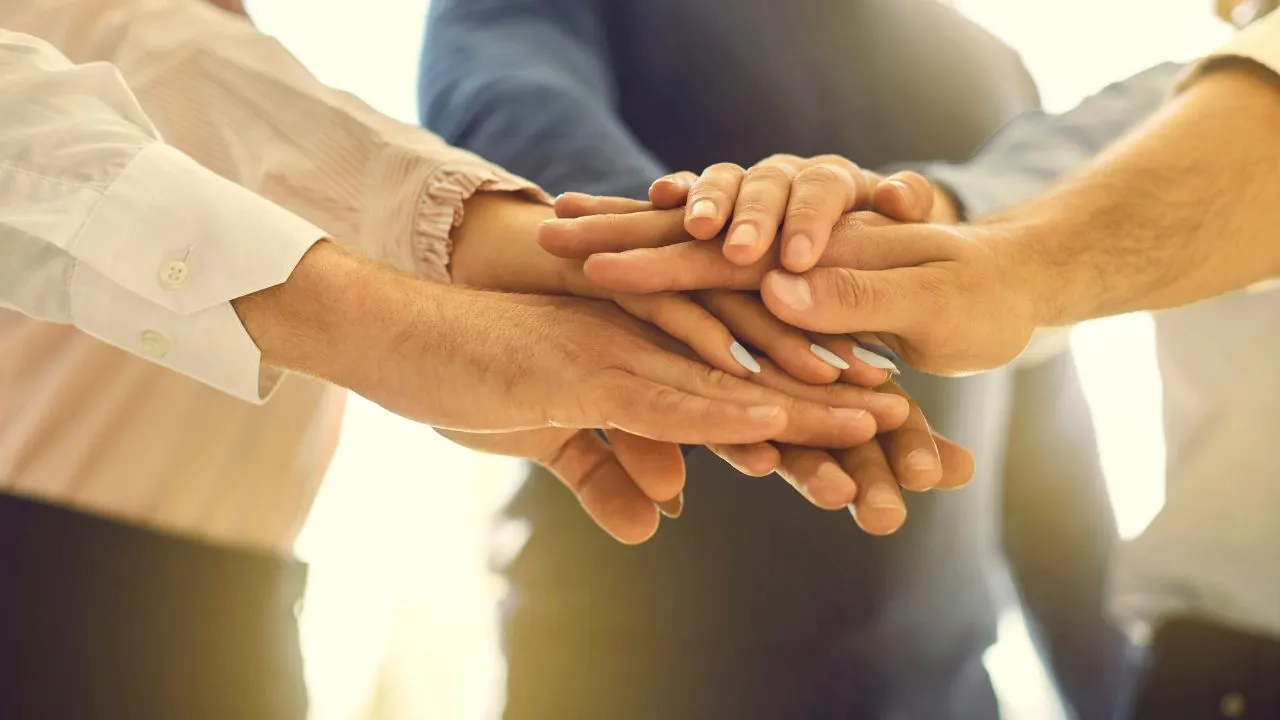 people stacking hands
